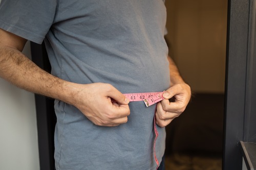 Man Measuring Waist Size