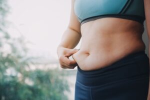 Woman Grabbing Belly Fat