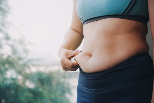 Woman Grabbing Belly Fat